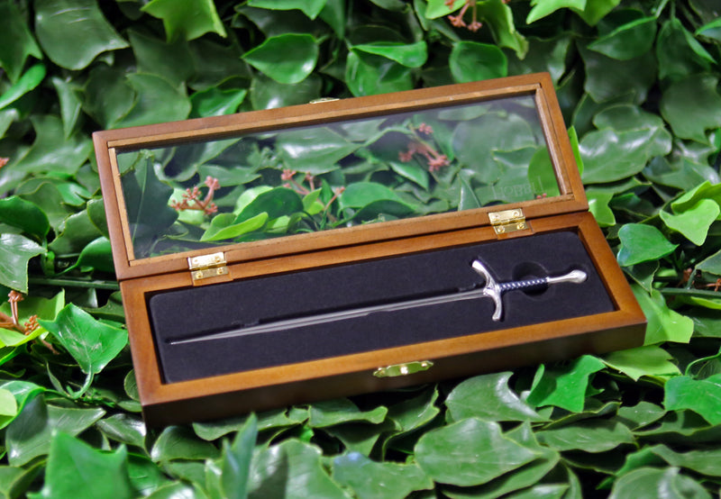 Glamdring sword replica letter opener in open wooden display box laying on a bed of ivy