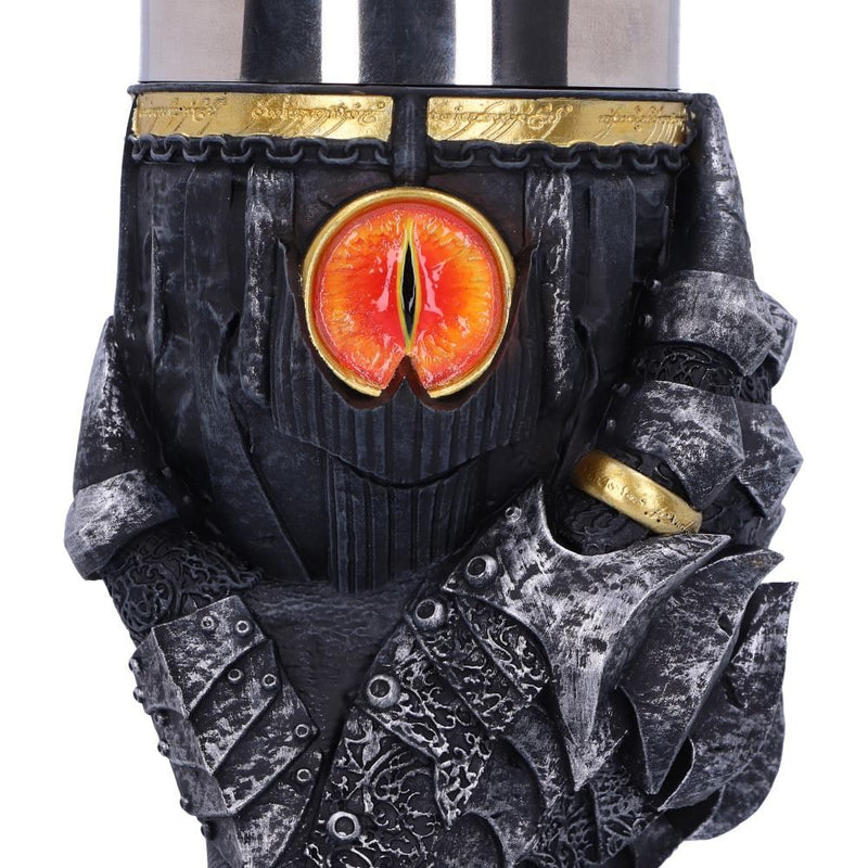 Close up detail of the eye of Sauron on the front of the goblet. The eye is nestled in the centre of the design, which is framed between the thumb and index finger of Saurons gauntlet. The one ring is visible on the index finger