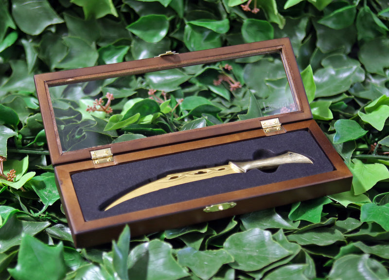 Tauriel’s dagger replica letter opener in open wooden display case on a bed of ivy