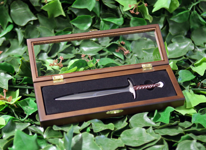 Sting sword replica letter opener in open wooden display box on a bed of ivy