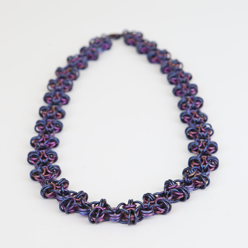 Intricately linked icy blue and rich purple chain necklace - closeup of chain links