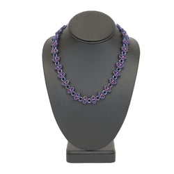 Intricately linked icy blue and rich purple chain necklace on display stand