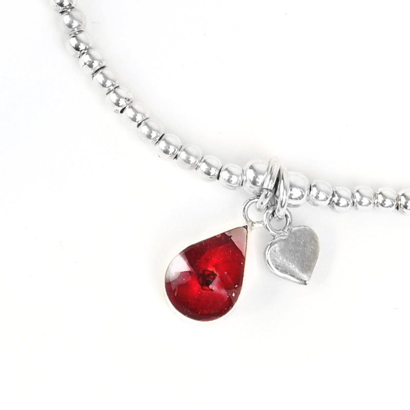 Beaded poppy bracelet with love heart charm detail