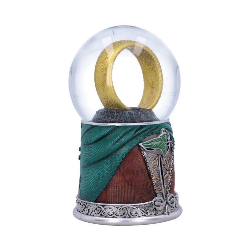 Decorative item with a gold ring inside a clear dome, green fabric, brown leather, and silver metalwork on a white background.