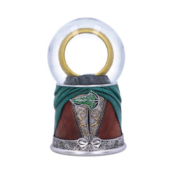Decorative one ring inside a clear glass sphere, green fabric, brown leather, and silver metalwork on a white background.