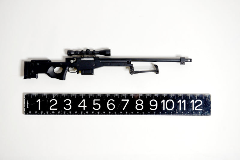 Assembled L96A1 model lying flat on its side and pointing to the right. Below it is a black ruler with white numbers, indicating the model is approximately 12 inches long