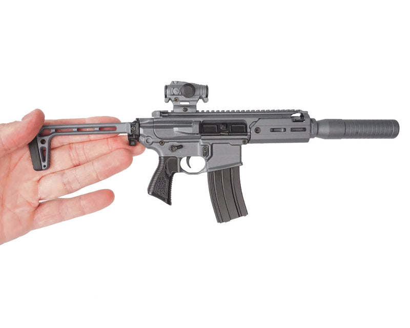Stone Grey SIG MCX model being held facing the right hand side