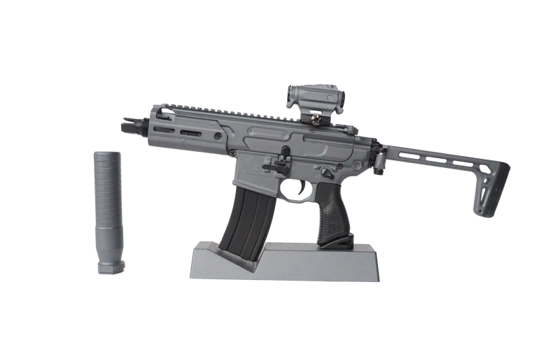Stone grey SIG MCX model on its display case facing towards the left hand side. The suppressor has been removed
