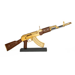 Model of gold plated AK47 on black display stand