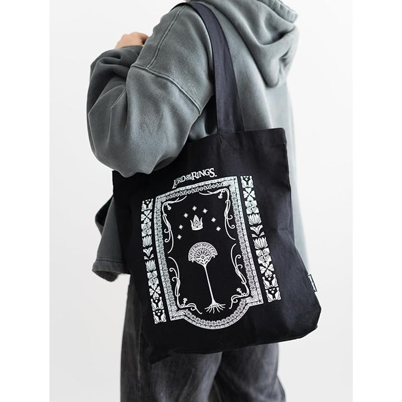 black graphic tote bag over a person's shoulder
