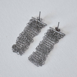Pair of distressed and treated silver chain mail drop earring with the appearance of being melted
