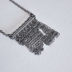 large distressed silver square chain mail pendant and chain with the appearance of being melted in parts