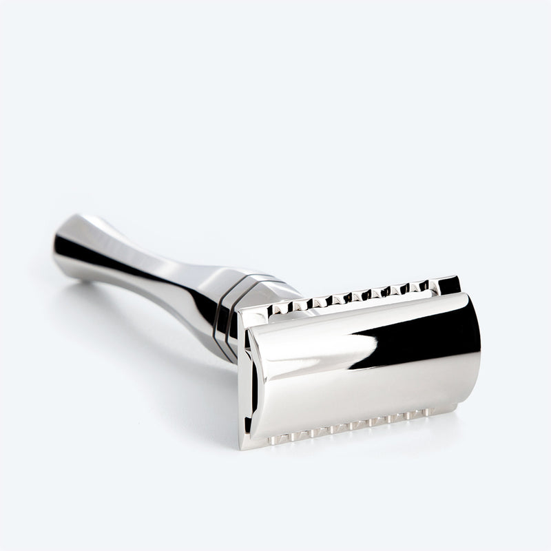 Line of Kings' Eltham Stainless Steel Safety Razor Lying on its side full view with focus on the razors head