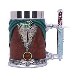 A steel tankard made in the image of Frodo Baggins. The tankard is wearing an emerald green cape, a brown waistcoat, a silver and gold undershirt, the One Ring on a chain, and a cloak pin in the shape of a leaf. The handle is in the shape of 'Sting', Frodo's sword, and is painted blue as if glowing. 