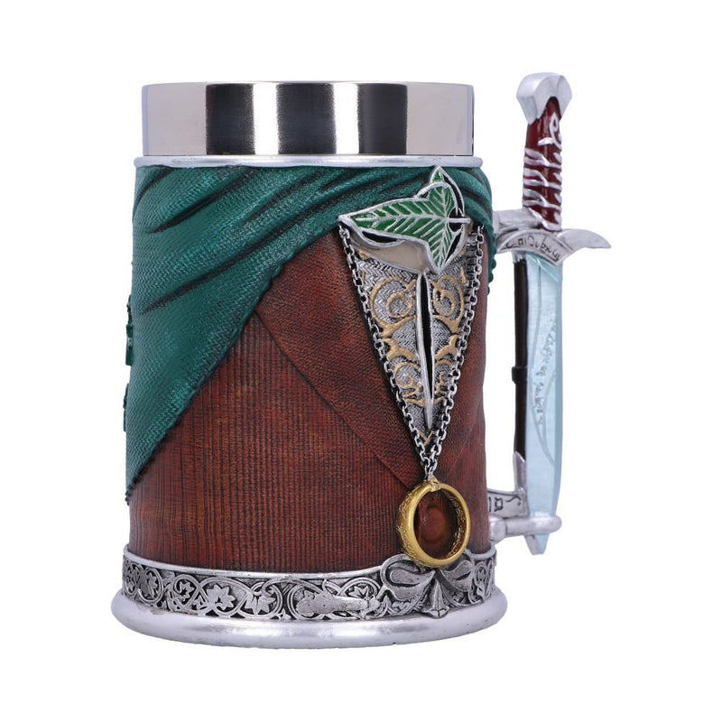 A sideview of a steel tankard made in the image of Frodo Baggins. The tankard is wearing an emerald green cape, a brown waistcoat, a silver and gold undershirt and a cloak pin in the shape of a leaf. The handle is in the shape of 'Sting', Frodo's sword, and is painted blue as if glowing. 