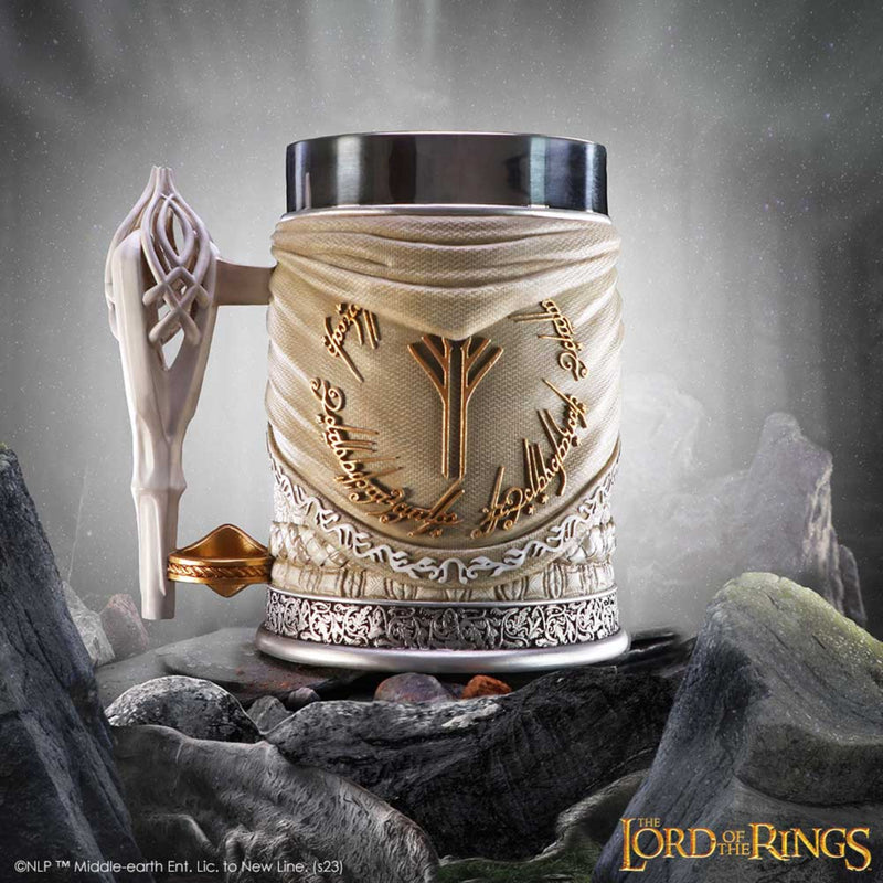 Decorative mug with intricate designs inspired by 'The Lord of the Rings' on a rocky background.