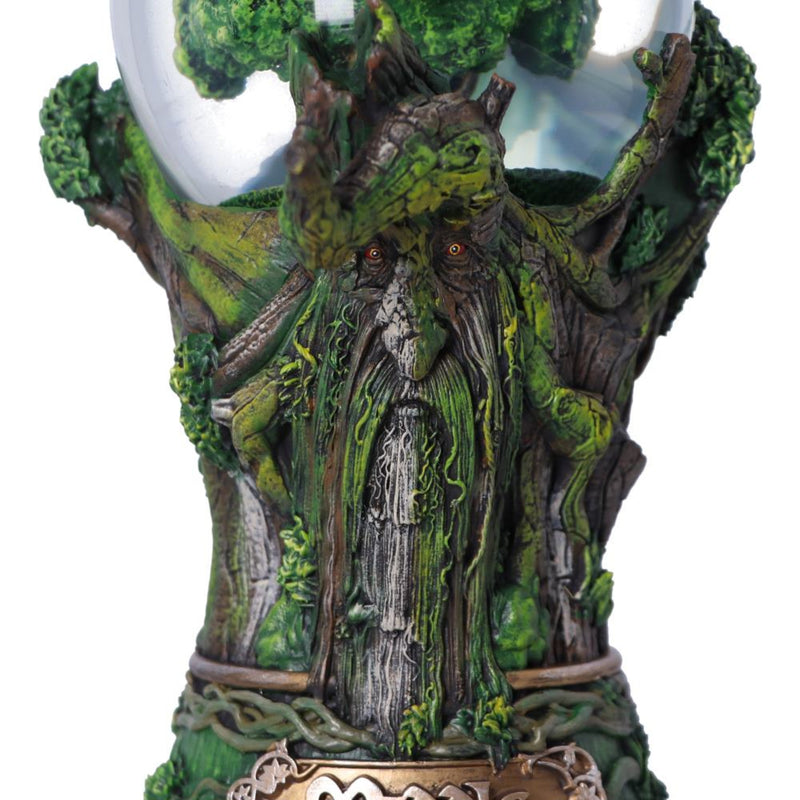 Statue of a tree-like creature with eyes and a mouth on a white background