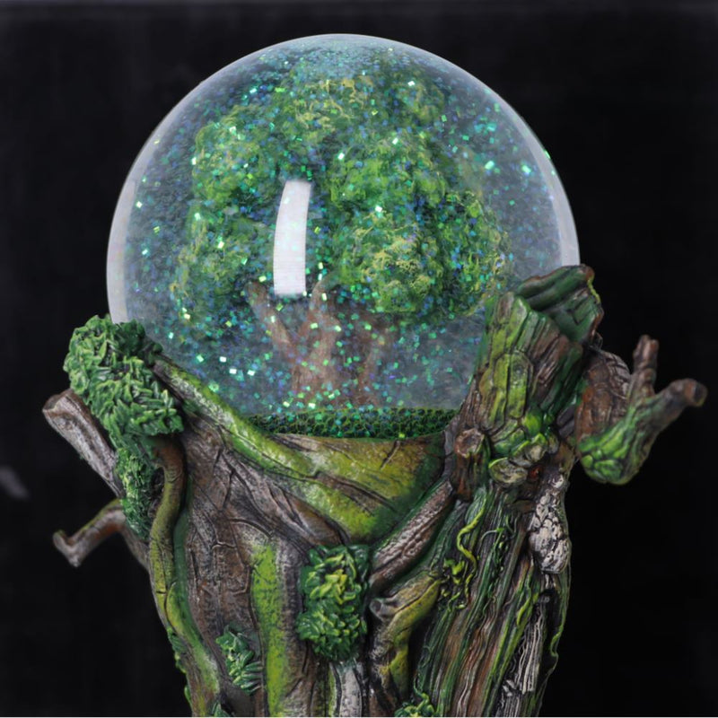 Decorative piece with a tree-like base and a crystal ball containing a forest scene.