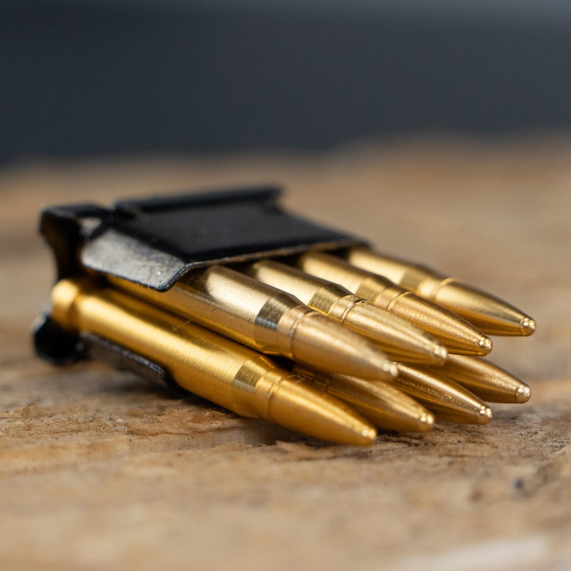 Close up of the M1 Garand model ammunition clip. The clip is Black and the ammo is gold