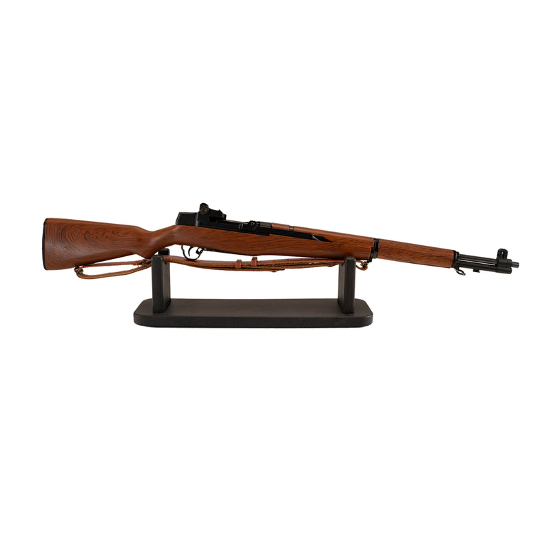 M1 Garand model resting on its black display stand, facing towards the right