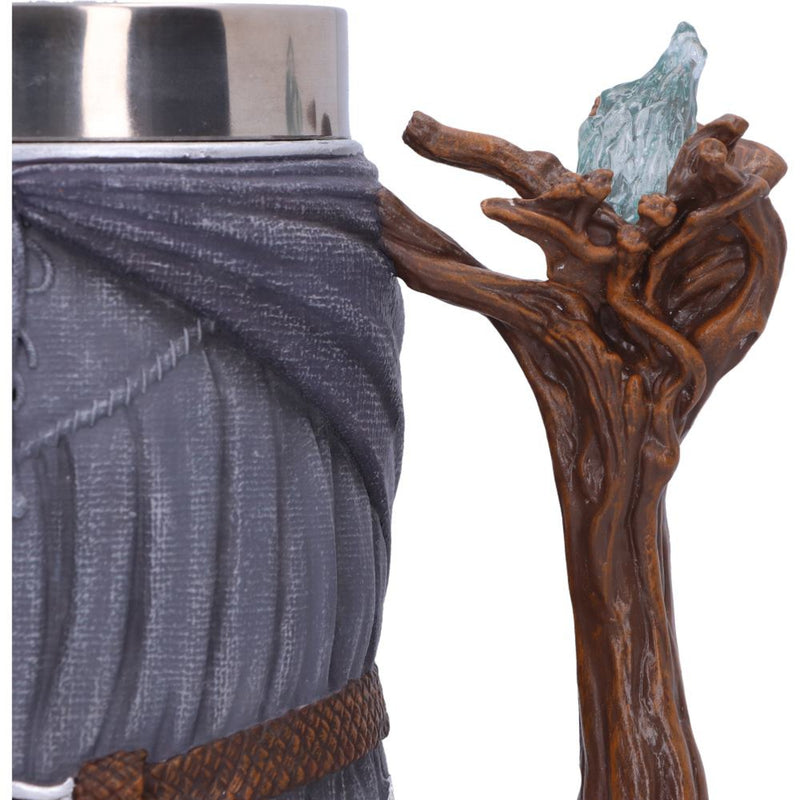 Mug with a decorative handle resembling a tree branch with a blue glass element.