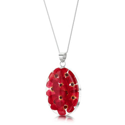 Clear resin oval poppy necklace with real flowers inside and silver hardware angled front view