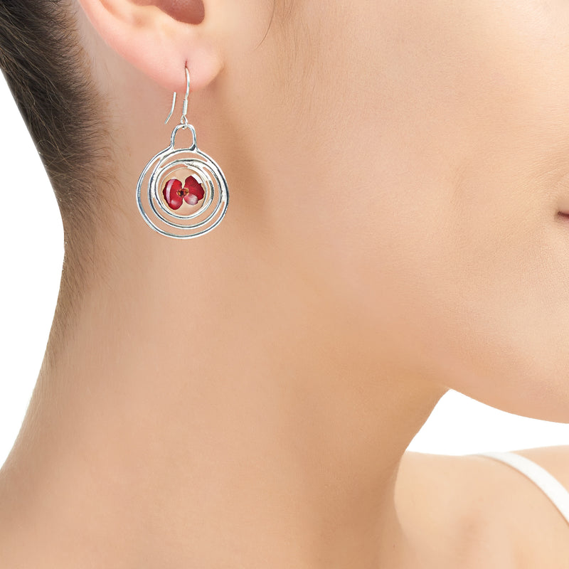 Spiral poppy drop earrings on model