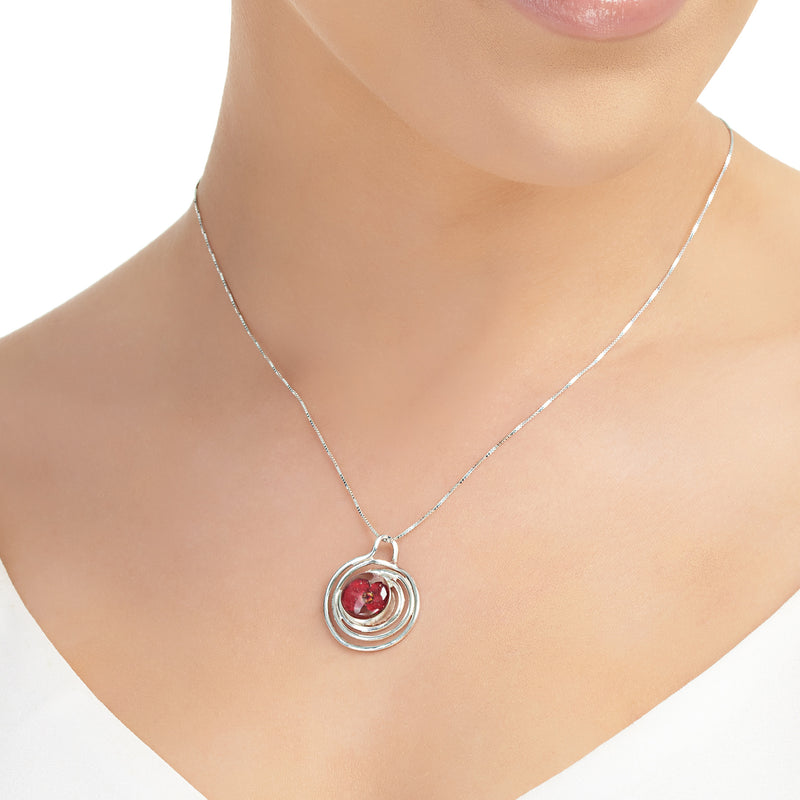 Spiral poppy pendant necklace around models neck
