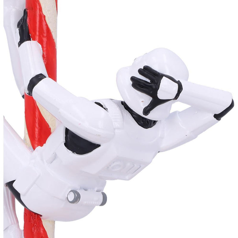Stormtrooper posed hanging off a candy cane hanging decorative ornament back left view close up of the hand on the back of the helmet