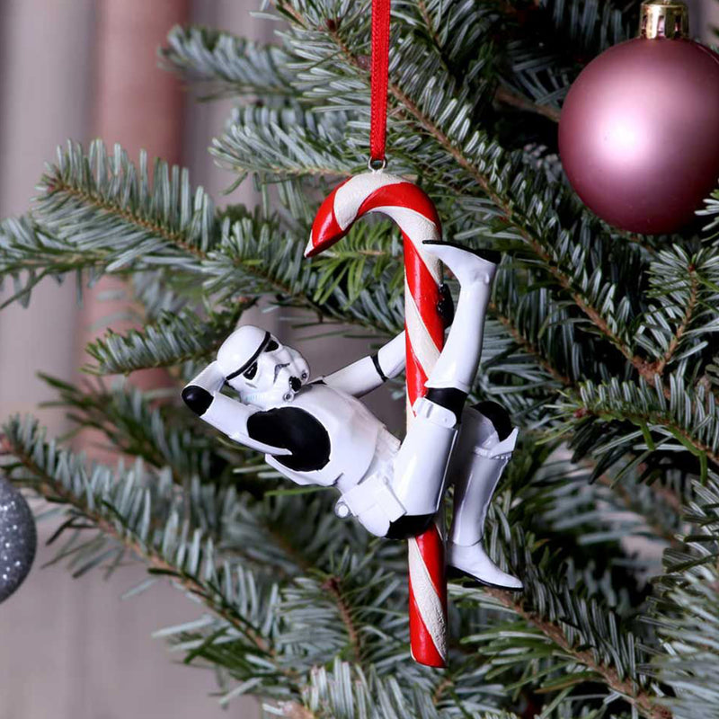 Stormtrooper posed hanging off a candy cane hanging decorative ornament front right view hanging from a christmas tree