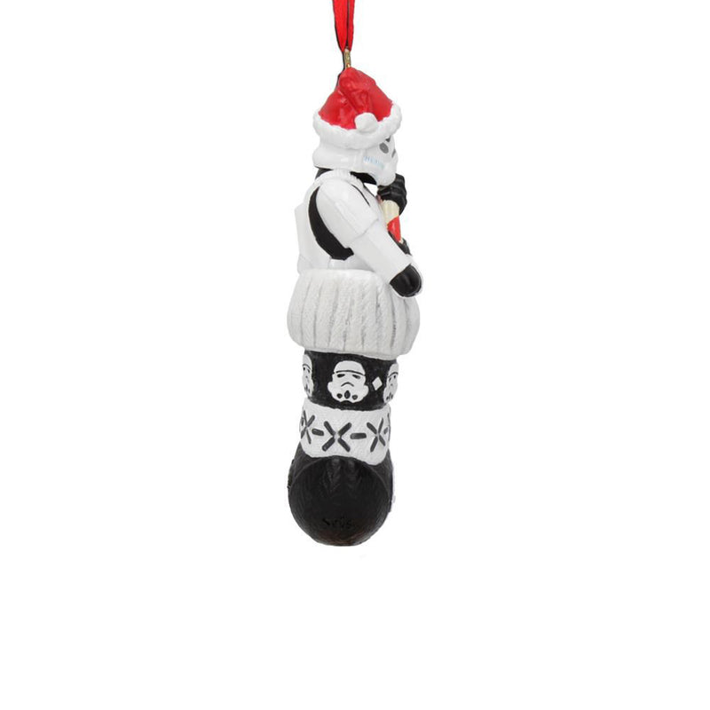 Stormtrooper in a stocking holding a candy cane like a blaster hanging decoration right side view