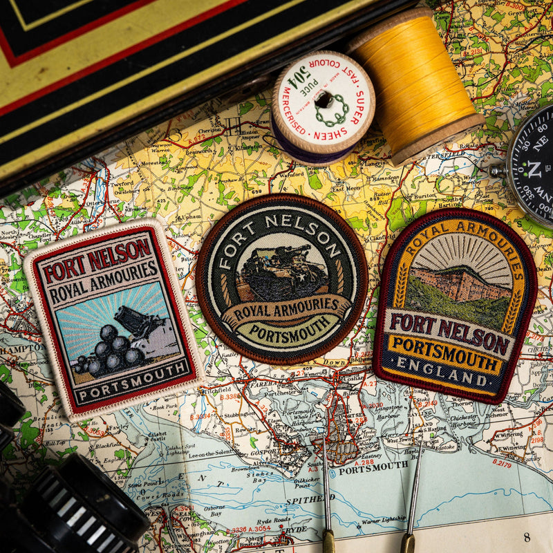 Three patches with 'Fort Nelson Royal Armories' branding on a map background.