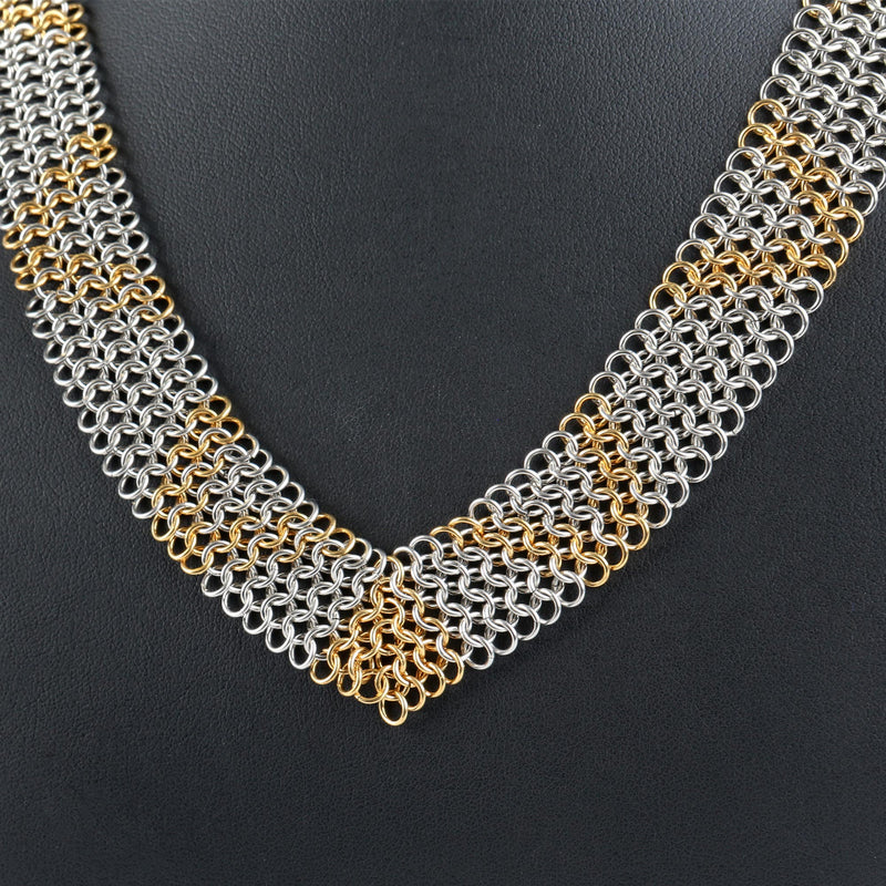 Gold and silver chainmail necklace, on a black background