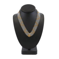 Necklace on a black mannequin bust with a white background