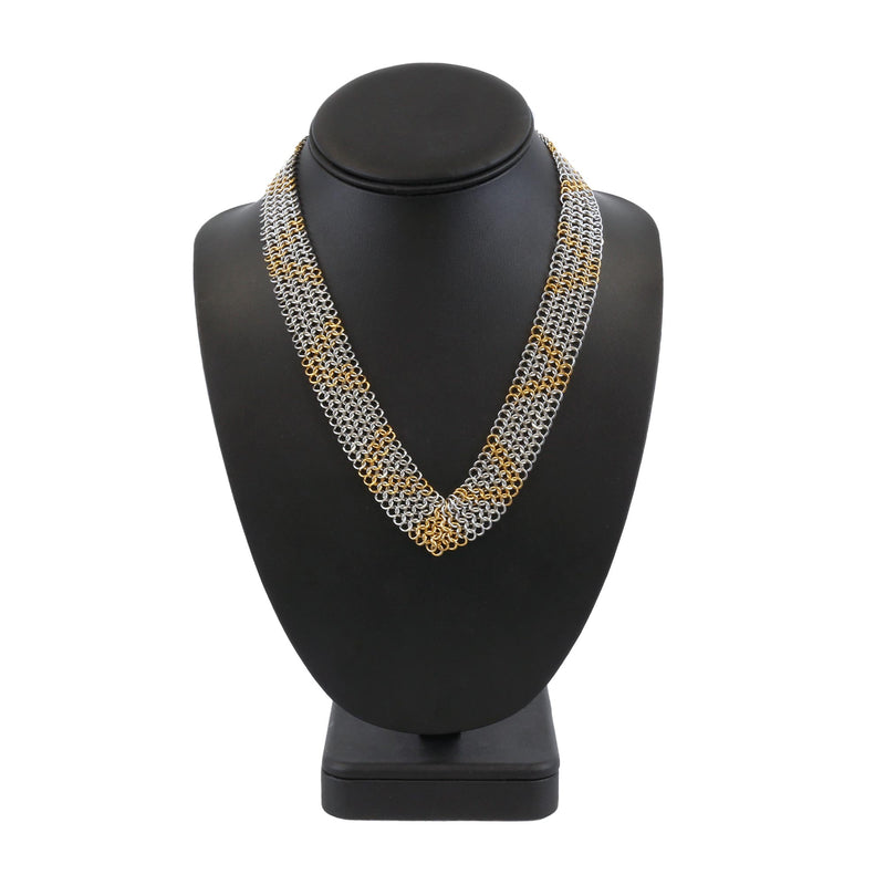 Necklace on a black mannequin bust with a white background