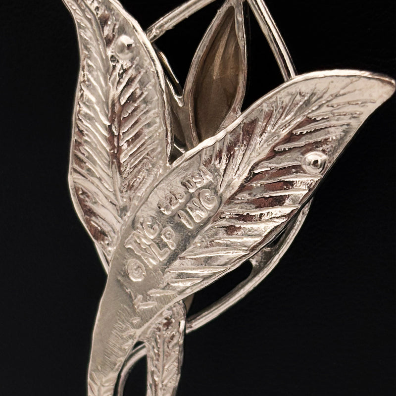 Silver leaf-shaped necklace close up of the silver stamp