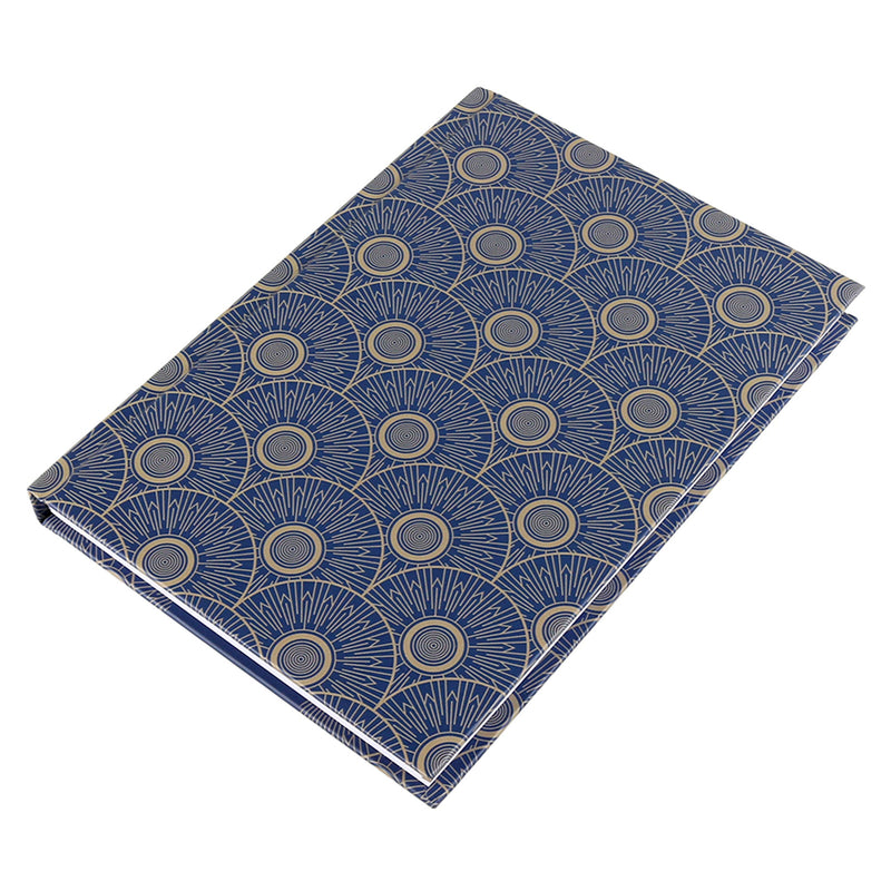 Notebook with gold and blue art-deco pattern laying flat on a white background