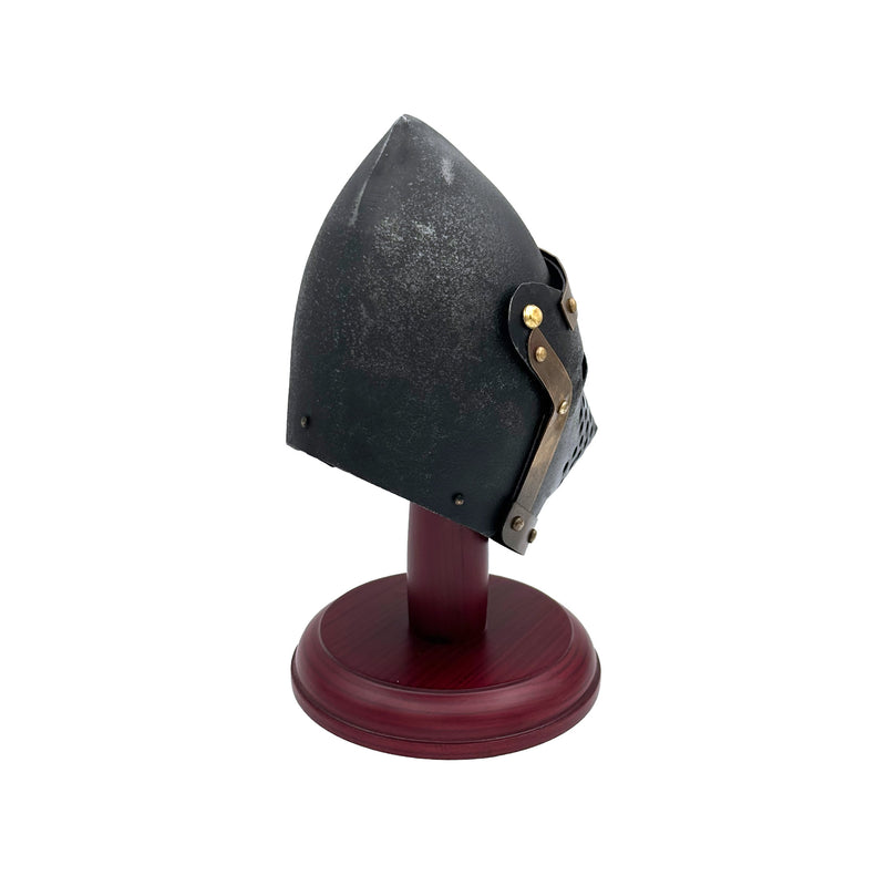 Black medieval helmet on a wooden stand against a white background