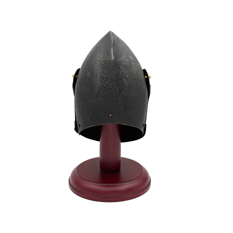 Black medieval helmet on a wooden stand against a white background