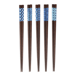 Set of five wooden chopsticks with blue patterned ends on a white background