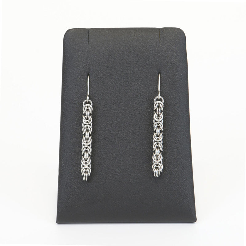 long byzantine style earrings on black display stand