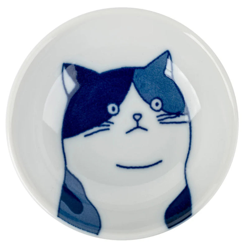 Round ceramic dish with a blue and white cat illustration on a white background