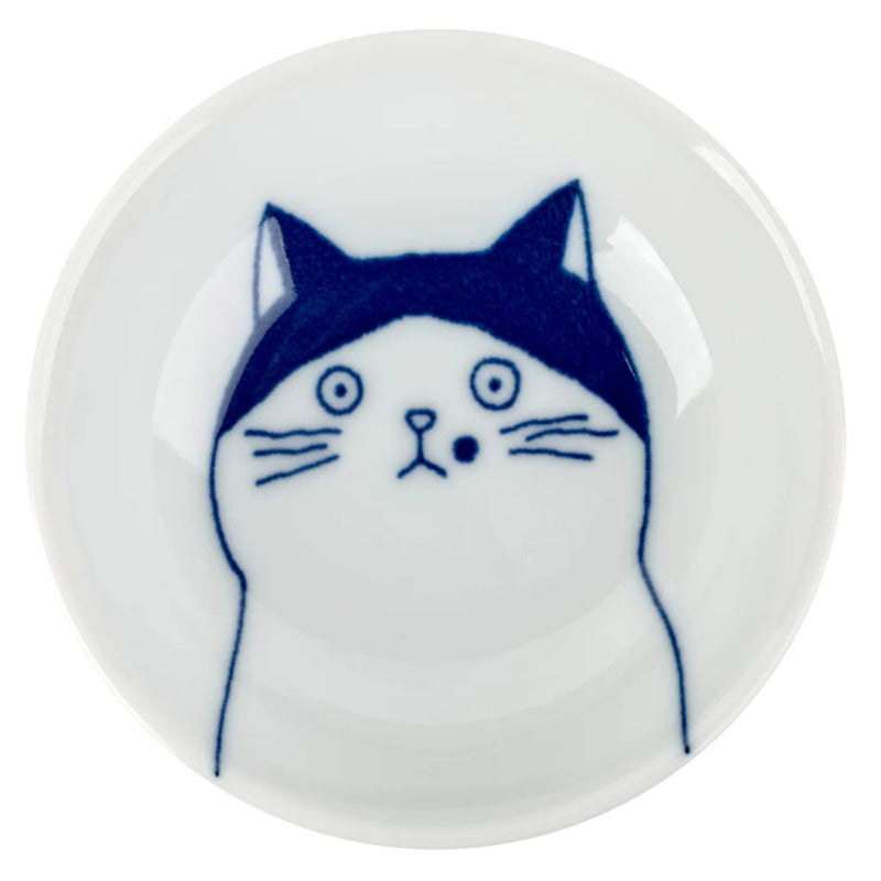 Round white dish with a blue and white cat illustration on a white background