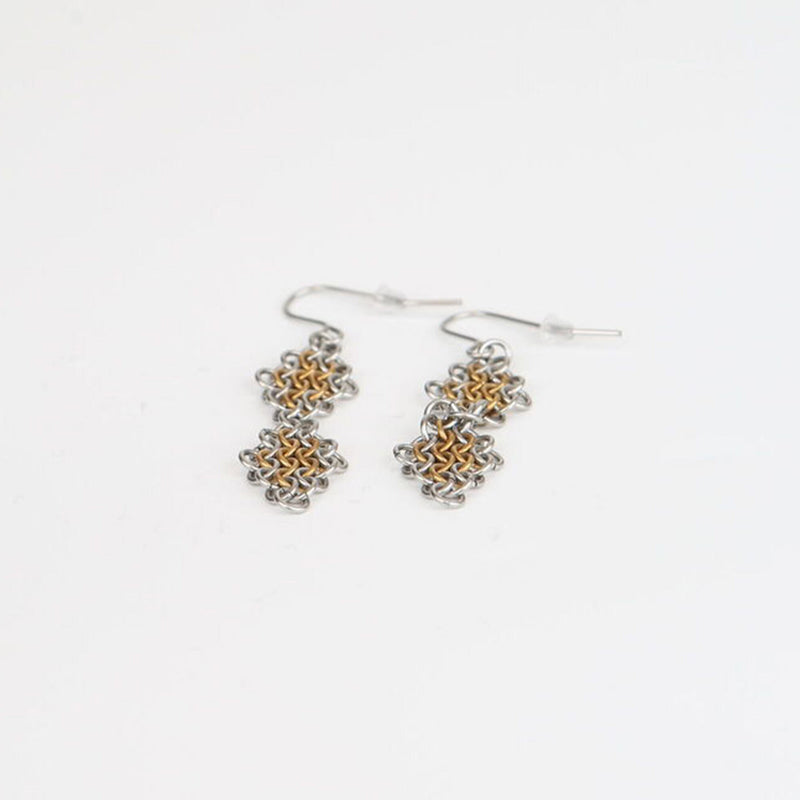 double diamond gold earrings laid down