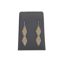 double diamond gold earrings on black display stand