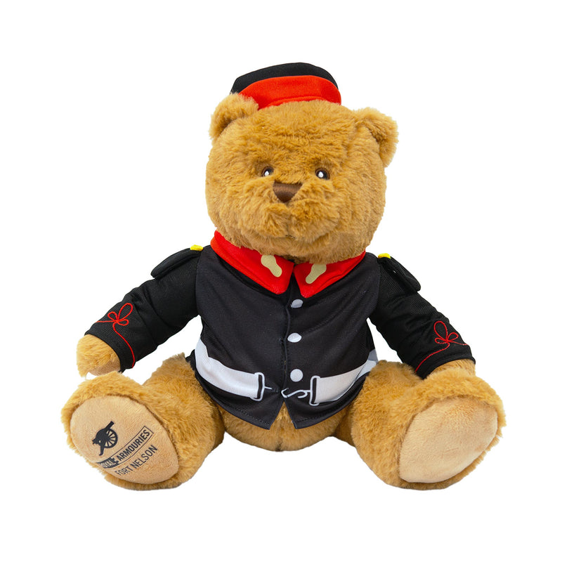 Teddy bear wearing victorian military uniform with royal armouries fort nelson logo on foot