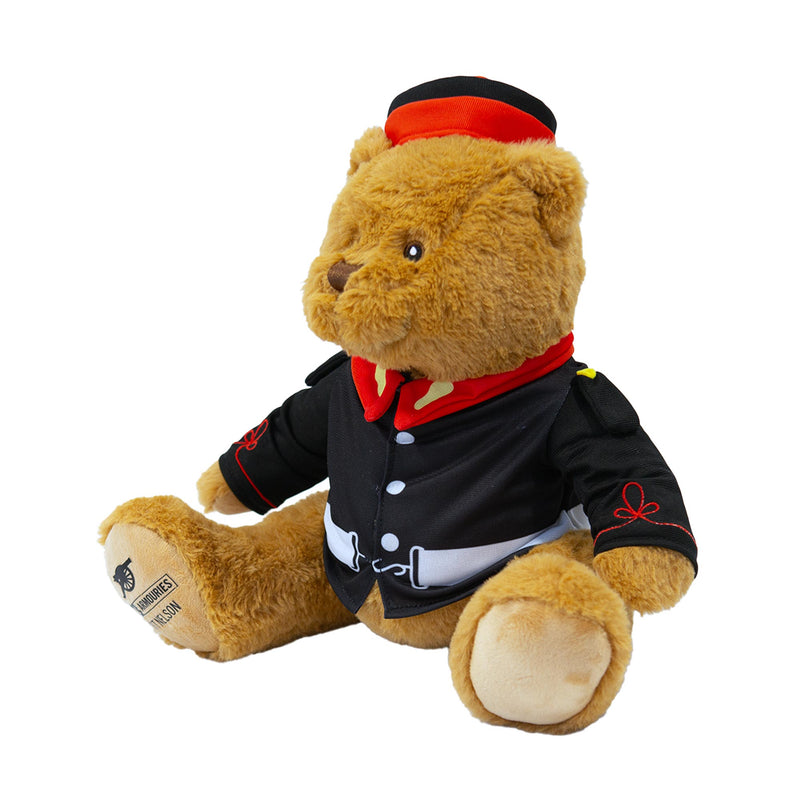 Teddy bear wearing victorian military uniform with royal armouries fort nelson logo on foot from side