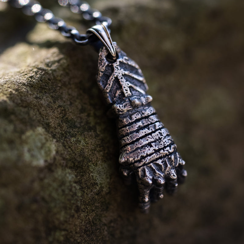 gauntlet pendant hanging outside palm down
