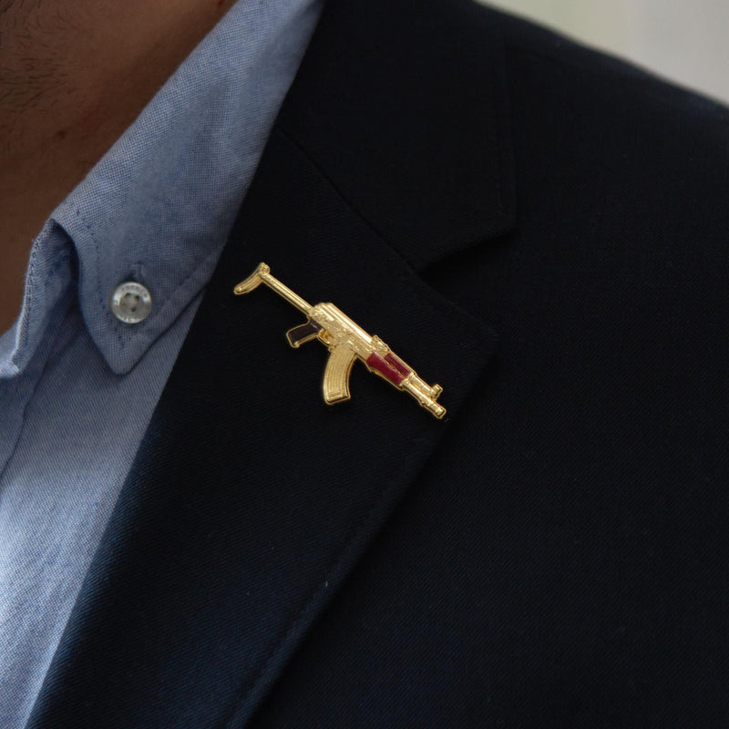 lifestyle image of golden ak47 pin badge on lapel