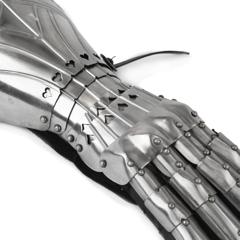 Close-up of a metallic gauntlet with intricate design on a white background